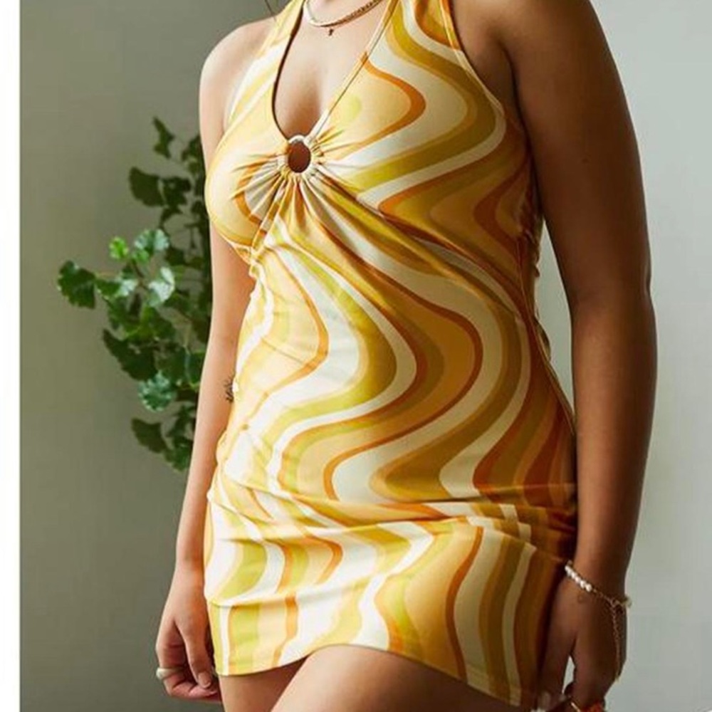 A halterneck dress, scooping V-neck with O-ring hardware and a cropped mini hem.